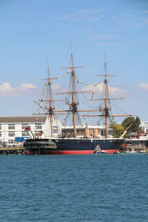 HMS Warrior moored in Portsmouth, England. HMS Warrior with her sister ship HMS Black Prince were the worlds first iron-clad warships.のeditorial素材
