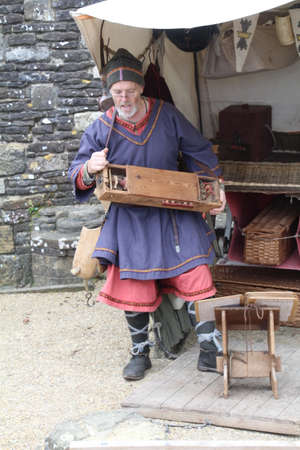 Battle, UK - 14 October, 2018: Man in saxon period clothing playing music from the period at a...