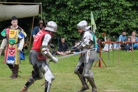 Battle, UK - 14 July, 2019: Knights tournament. Held throughout the Summer at several locations. Four knights re-enactors compete against each other in a series of trials using swords, longbow, mace etc, to establish who is the champion.のeditorial素材