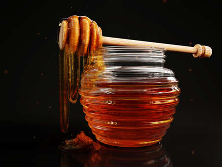 Honey Pot with a Honey Spoonの写真素材
