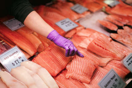 Purple finger pointing to salmon. Taken in Philadelphia, Pennsylvania.の写真素材