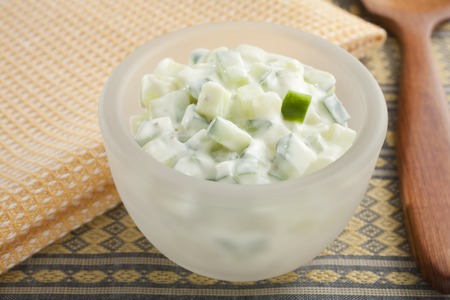 A bowl of cucumber raita Indian food accompanimentの写真素材