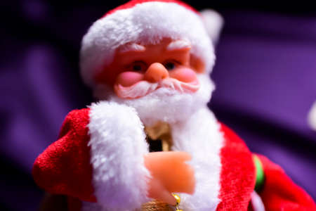 Santa Claus doll on a purple backgroundの写真素材