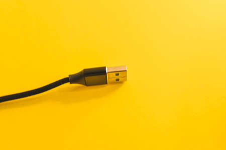 USB cable on a yellow background. Close-up. Copy space.の写真素材