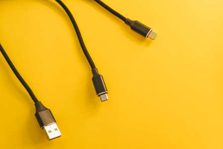USB cable isolated on yellow background. Top view. Copy space.の写真素材