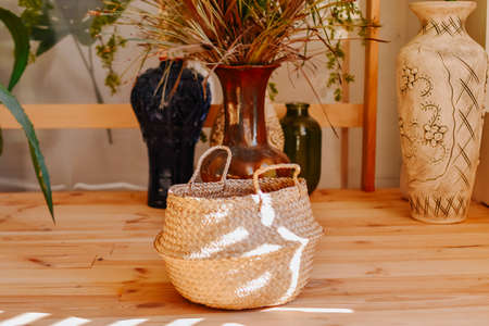 Handmade wicker bag on the wooden table. Eco friendly conceptの写真素材