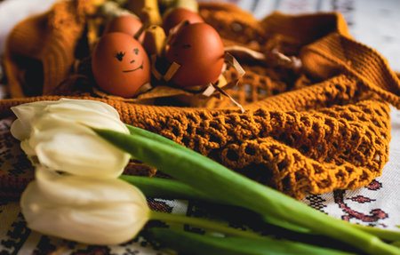 Easter eggs on rustic table with white tulips. high quality photoの写真素材