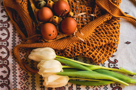 Easter eggs on rustic table with white tulips. high quality photo