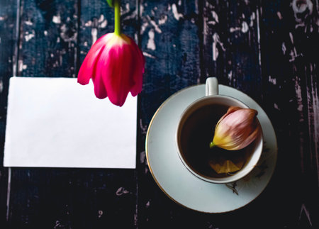 Tee cup on wooden background Tee cup on wooden background with spring tulips and white sheet and with spring tulips and white sheet. High quality photoの写真素材