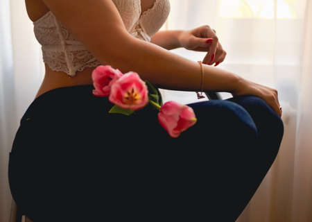 happy woman with spring flowers on window. High quality photoの写真素材