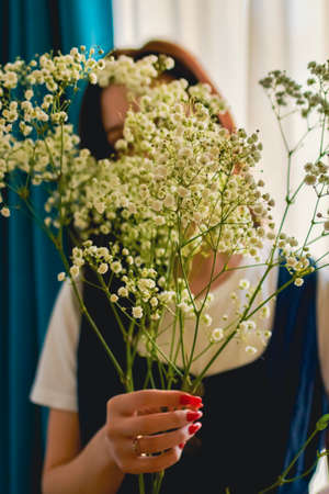 happy woman with spring flowers on window. High quality photoの写真素材