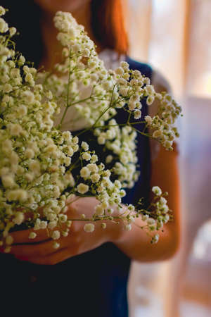 happy woman with spring flowers on window. High quality photoの写真素材