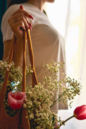 happy woman with spring flowers on window. High quality photoの写真素材