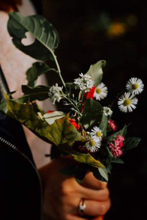 Bouquet of wildflowers in the hands of a girl