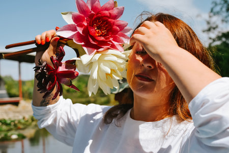 Portrait of a beautiful red-haired girl with flowers in her hair.の写真素材