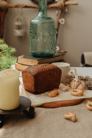 Chocolate cake with nuts and a candle on the table in the kitchenの写真素材