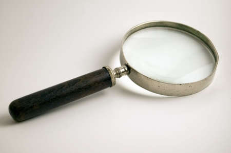 An old magnifying glass on white.の写真素材