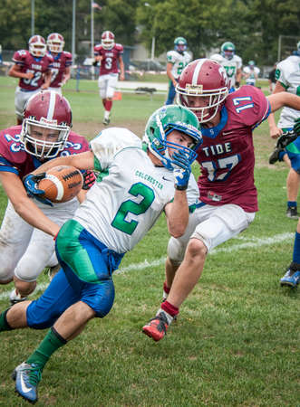 A highschool football player makes a run for the end-zone during a highschool football game in Vermontのeditorial素材