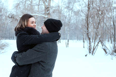 Adult couple resting in park, embrace and smilling of lovingの写真素材