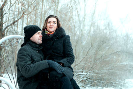 Adult couple resting in park, embrace and smilling of lovingの写真素材