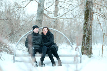 Adult couple resting in park, embrace and smilling of lovingの写真素材