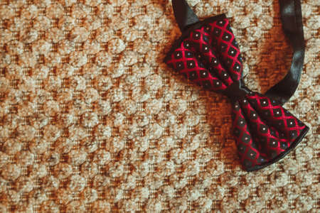 Wedding rings and bow ties on tableの写真素材