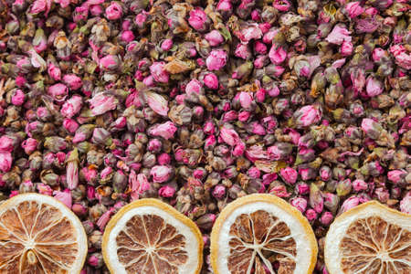 Tea flowers texture. Peach blossom tea with lemon. Organic dried flower tea leavesの写真素材