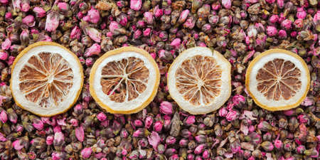 Tea flowers texture. Peach blossom tea with lemon. Organic dried flower tea leavesの写真素材