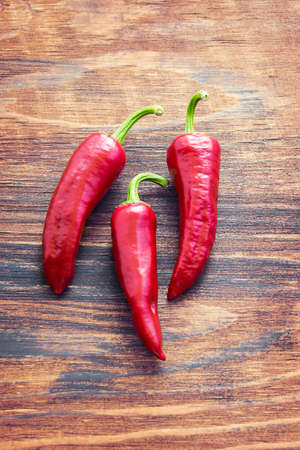 Red hot chili pepper on a wooden background