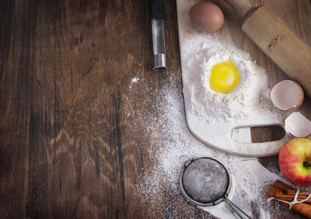 Baking background with raw egg, flour and apple, empty templateの写真素材