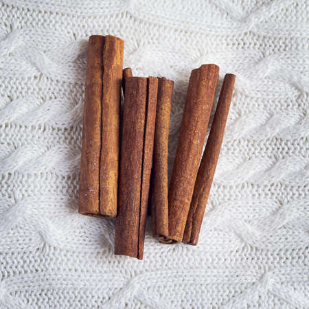 Cinnamon sticks on a white background knitted plaidの写真素材