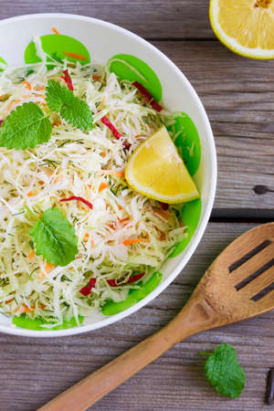 Vitamin cabbage salad with carrots in a bowlの写真素材