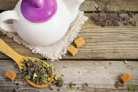 White teapot, dry herbal tea and brown sugar. with space for textの写真素材