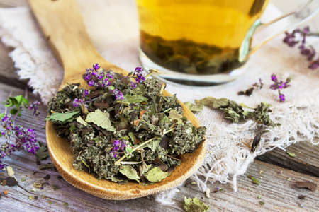 Wooden spoon with dry herbal tea.の写真素材