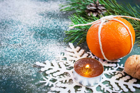 Christmas card: mandarin, candle, fir branch and snowflake. with space for textの写真素材