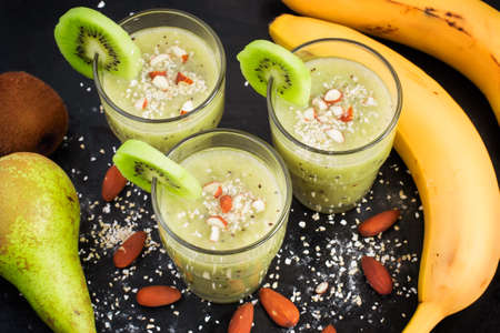 nutritious smoothie with oat bran and almonds on a black backgroundの写真素材