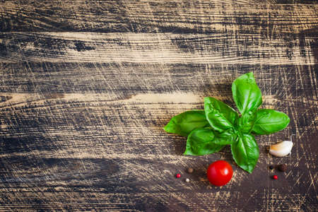 Basil leaves and spices on Shabby wooden background. Space for textの写真素材