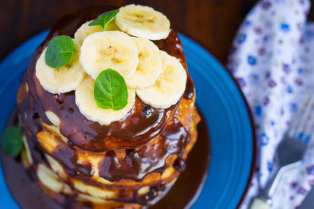 Pancakes with banana and chocolate, selective focus.の写真素材