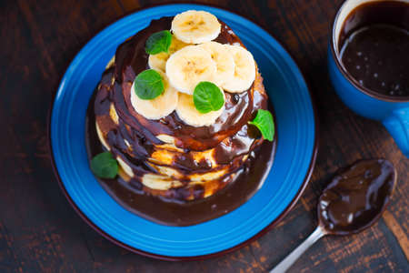 Pancakes with banana topped with chocolate. Top view.の写真素材
