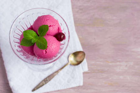 Cherry ice cream on a pink background, top view, space for text.の写真素材