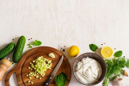Background with the ingredients  for cooking tzatziki sauce.の写真素材