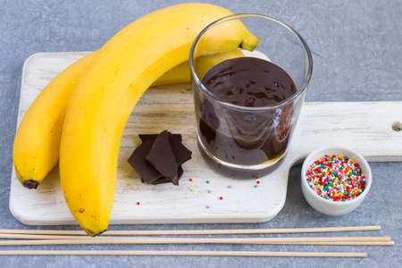 Ingredients for Banana Pops on a cutting board.の写真素材
