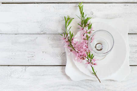 Spring table setting, white plate and wine glass decorated with flowering almonds