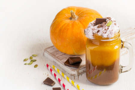 Pumpkin and chocolate smoothie with whipped cream, copy space.の写真素材