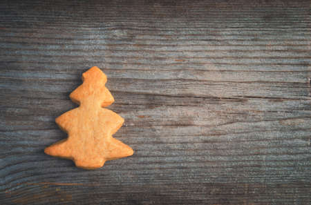 gingerbread in form of fir on the old wooden background, christmas background, tintedの写真素材