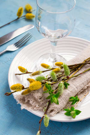 Spring Easter Table setting on a blue wooden table.
