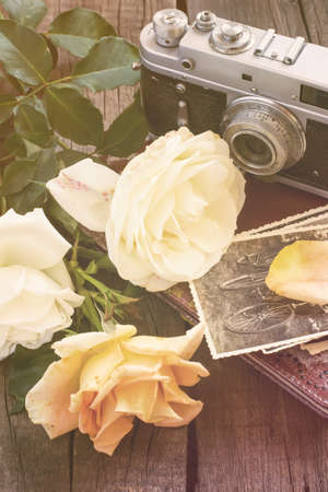Old camera family photos and roses. Vintage tinted.の写真素材