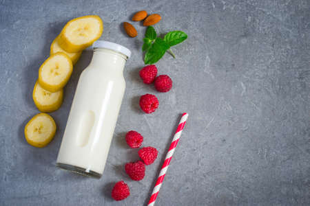Ingredients for milkshake with juicy ripe raspberries and almondの写真素材