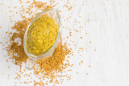 French mustard sauce and mustard seeds on white background. Topの写真素材