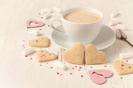 Valentines day heart shaped cookies and cup of coffee, tinted